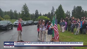 Volunteers honor fallen veterans in Lynnwood by placing flags on graves